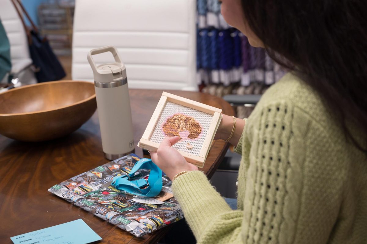 Stitch Social BR co-creator Caroline Cantrelle works on her latest project, Monday, March 17, at the Elegant Needle. 
